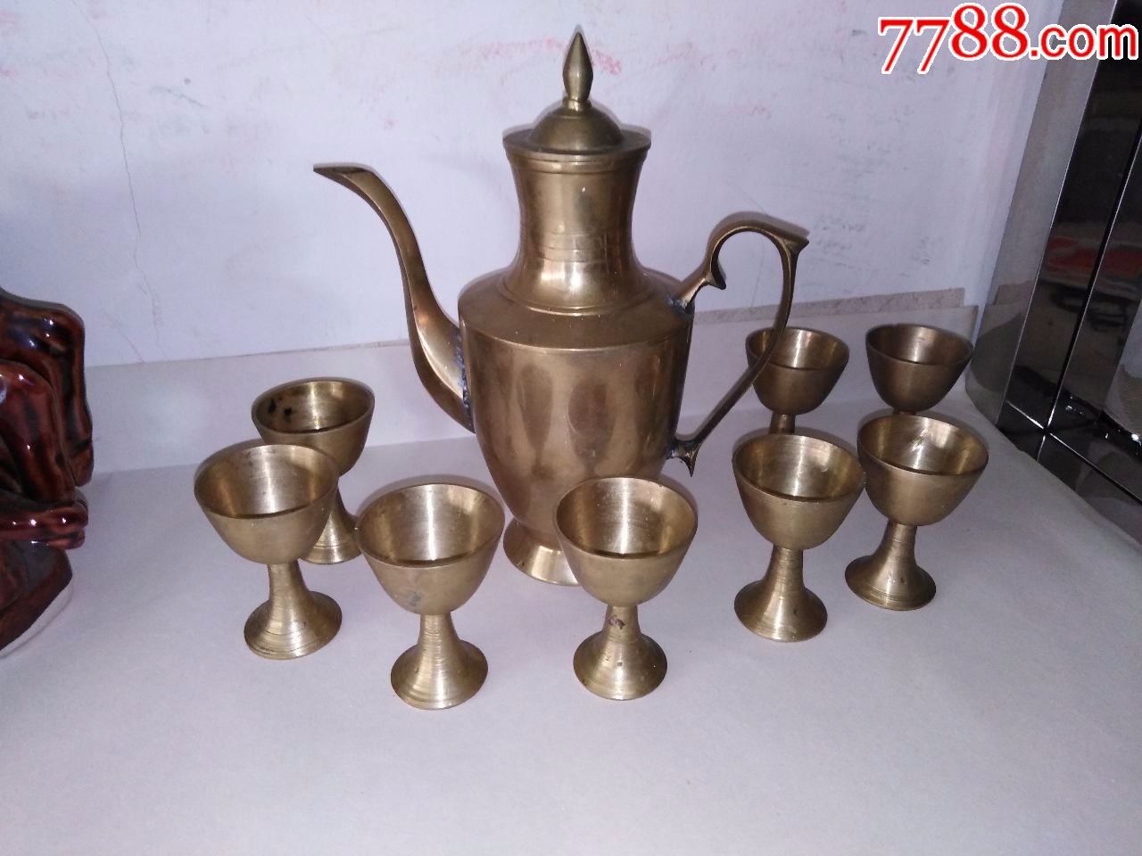 铜酒壶酒杯共九件,300元